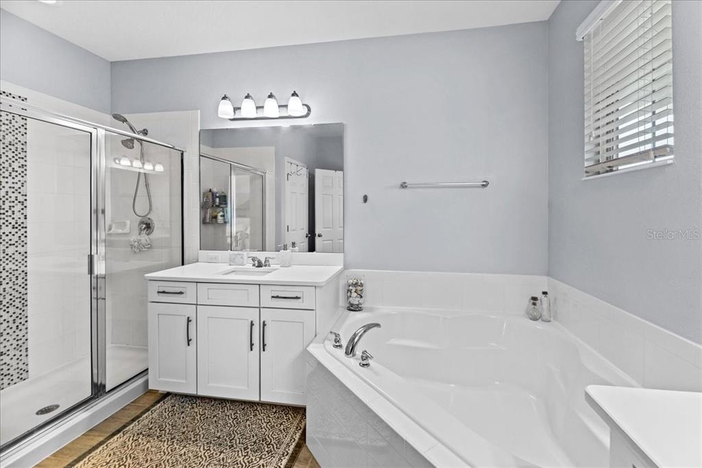 8746 Crescendo Avenue Windermere, FL 34786 - Photo 32 of 56 a bathroom with a tub sink and mirror