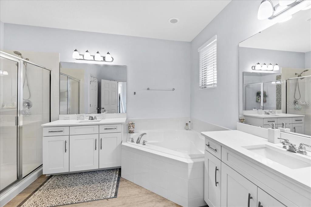 8746 Crescendo Avenue Windermere, FL 34786 - Photo 33 of 56 a spacious bathroom with a double vanity sink mirror and bathtub