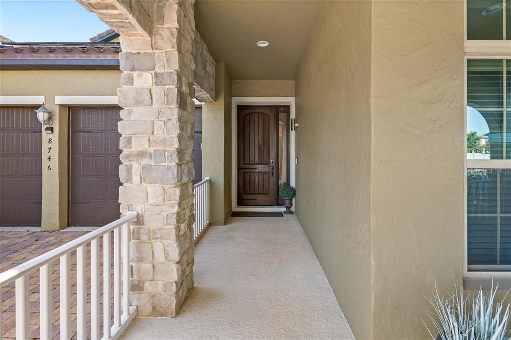 8746 Crescendo Avenue Windermere, FL 34786 - Photo 4 of 56 a view of a brick house with a wooden fence