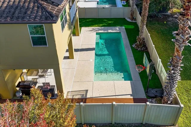 a view of a house with backyard and sitting area