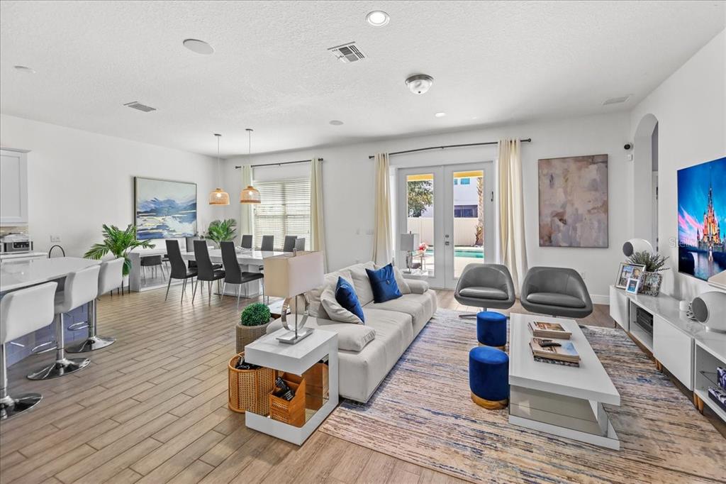 8746 Crescendo Avenue Windermere, FL 34786 - Photo 6 of 56 a living room with furniture a flat screen tv and a table