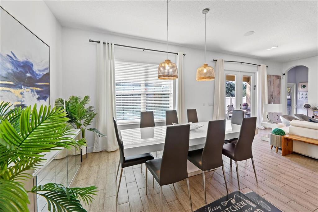 8746 Crescendo Avenue Windermere, FL 34786 - Photo 10 of 56 a view of a dining room with furniture window and wooden floor