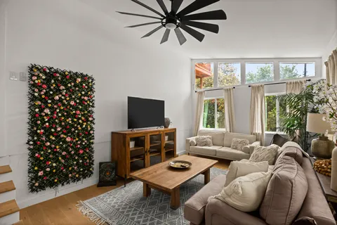 a living room with furniture a rug and a flat screen tv