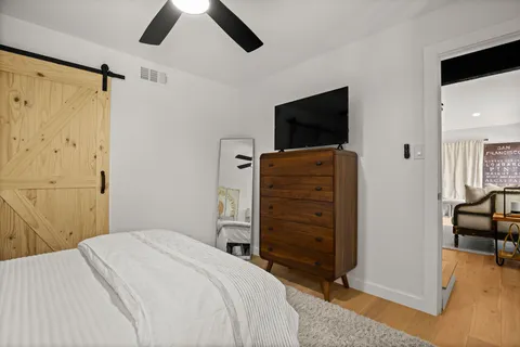 a bedroom with a bed and a flat screen tv