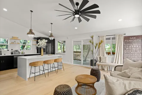a living room with furniture a window and a chandelier