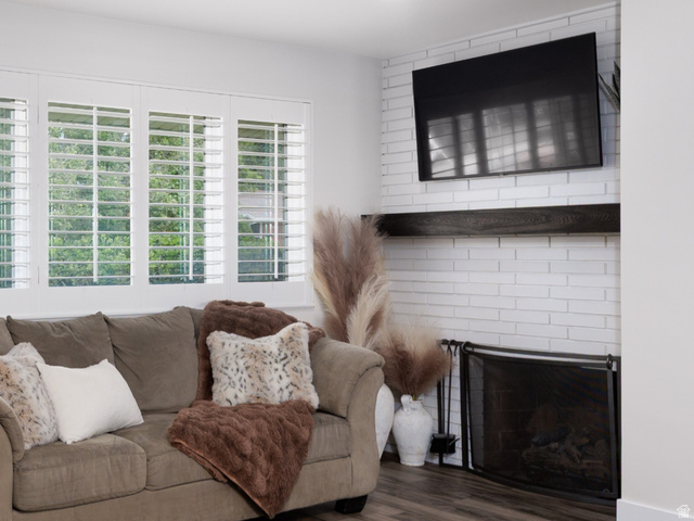 8252 Wood Street Midvale, UT 84047 - Photo 10 of 40 Open-concept living area featuring wood-finish flooring, recessed lighting, and brick fireplace