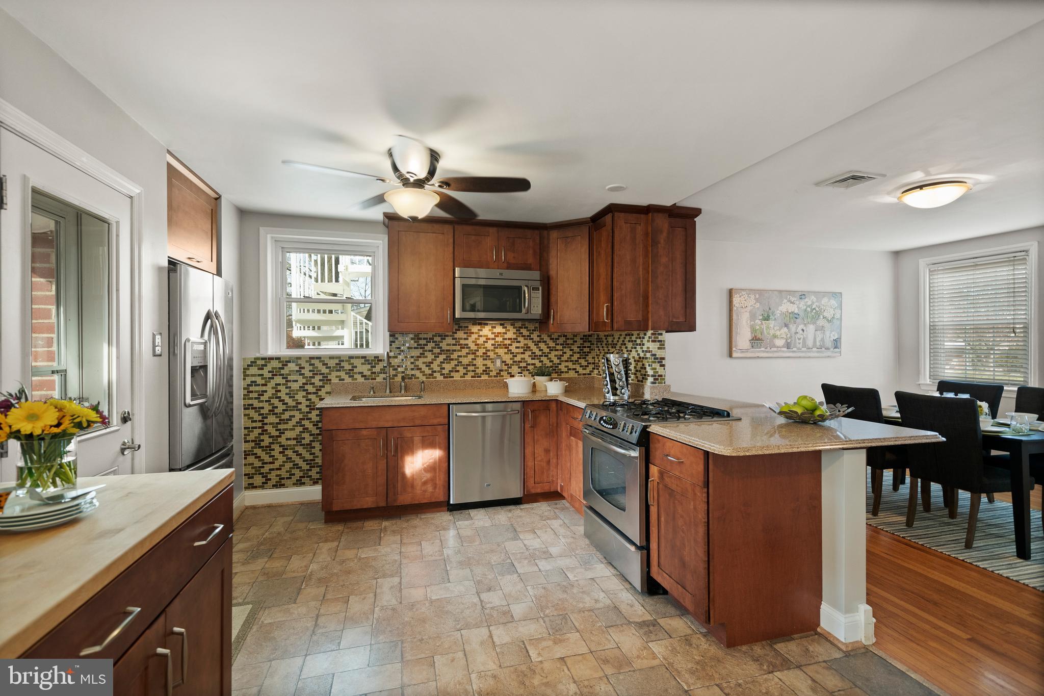 302 Shelbourne Road Havertown, PA 19083 - Photo 13 of 45 a kitchen with stainless steel appliances granite countertop a stove a sink dishwasher and a refrigerator with wooden cabinets