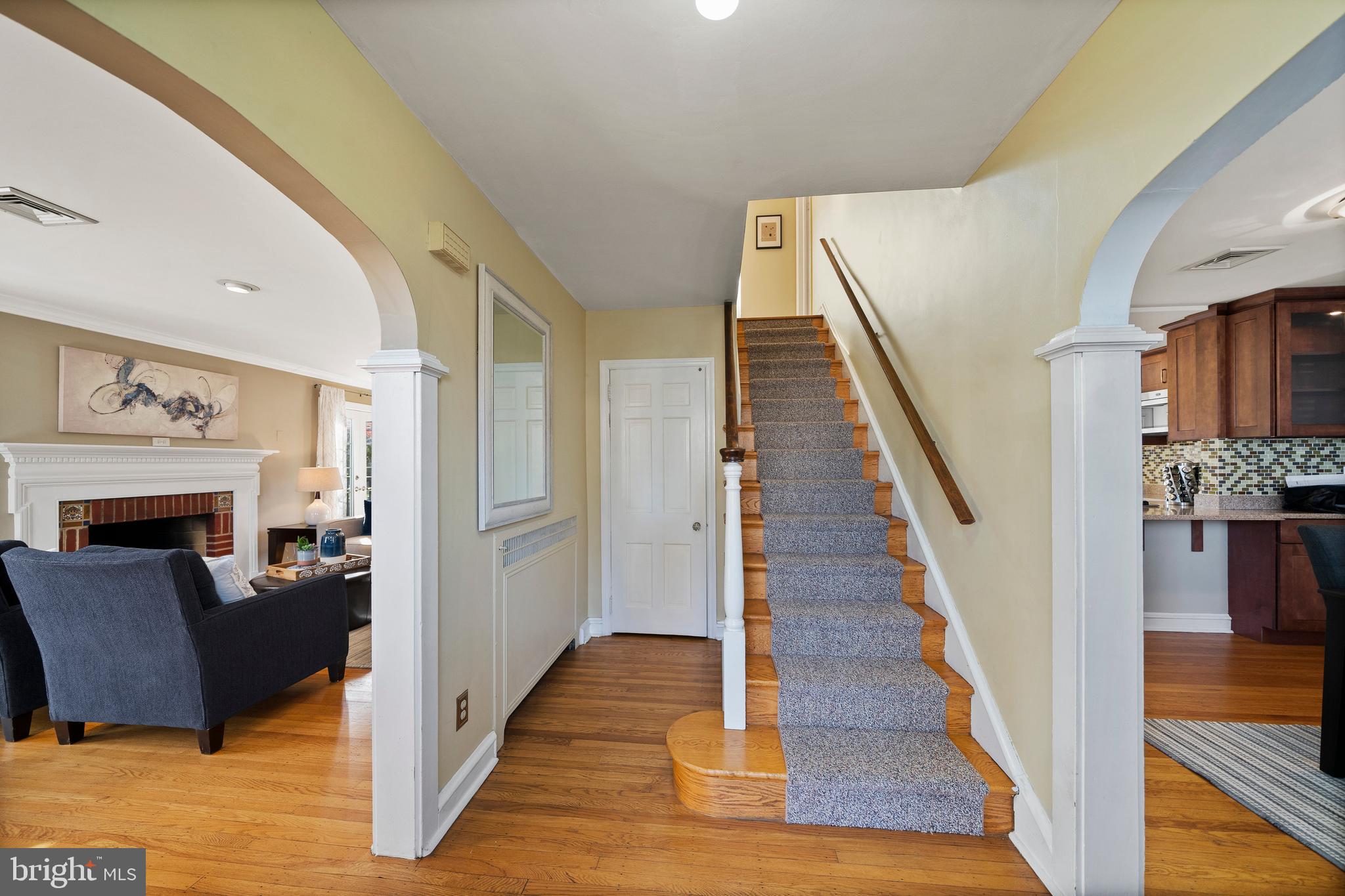302 Shelbourne Road Havertown, PA 19083 - Photo 3 of 45 a view of a livingroom with a fireplace wooden floor and staircase