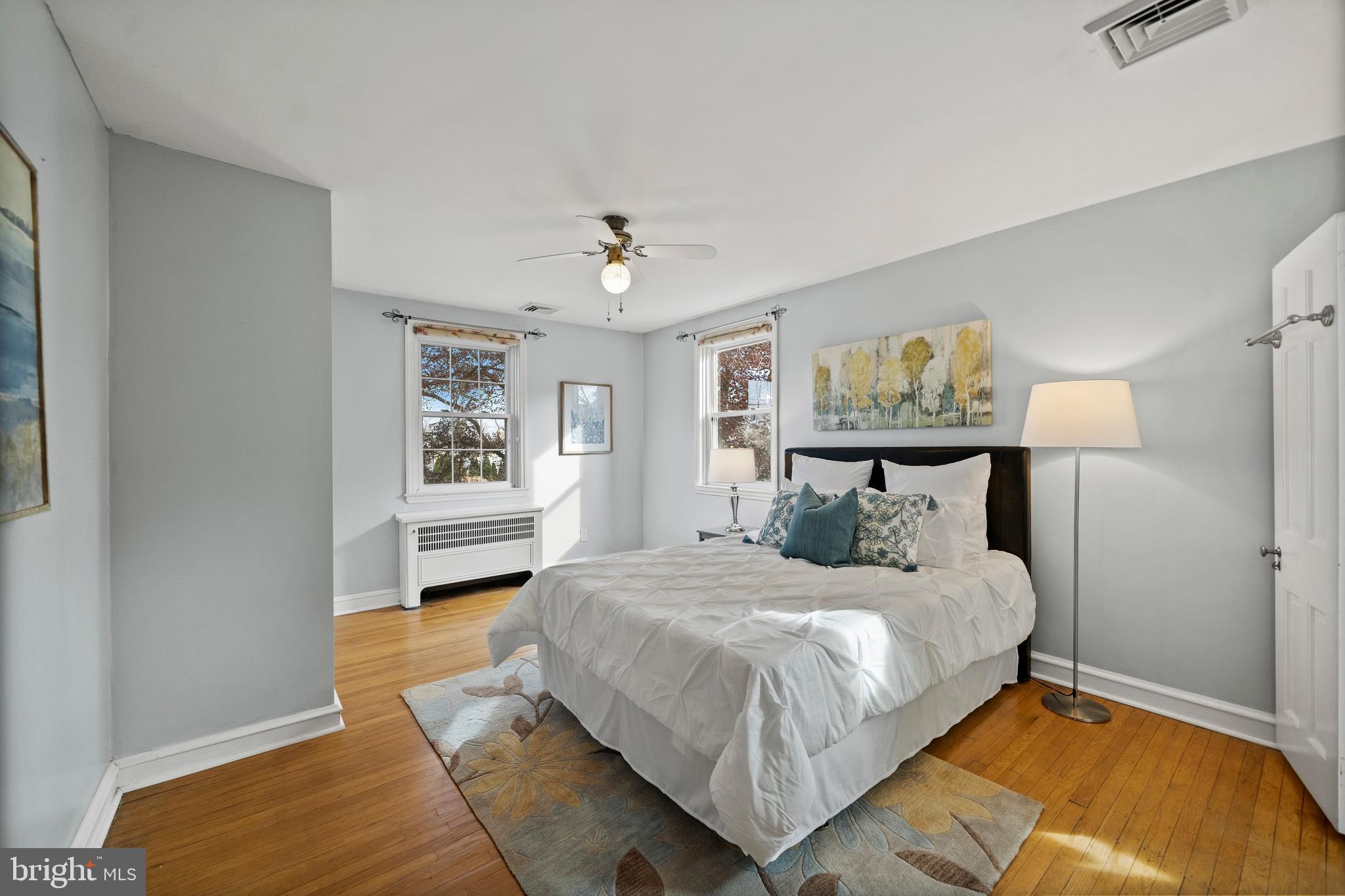 302 Shelbourne Road Havertown, PA 19083 - Photo 23 of 45 a bedroom with a large bed a chandelier and windows