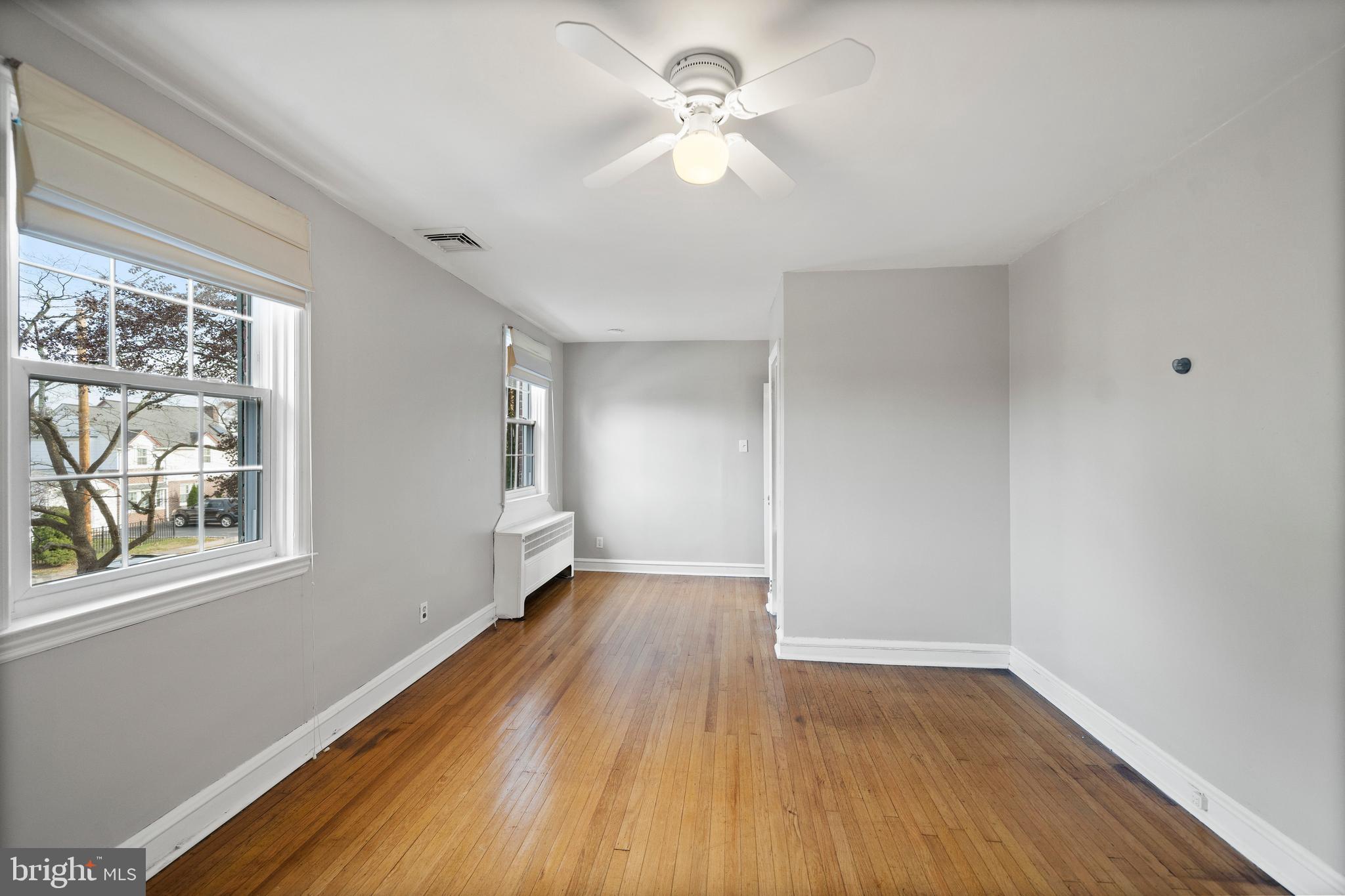 302 Shelbourne Road Havertown, PA 19083 - Photo 32 of 45 a view of an empty room with wooden floor and a window