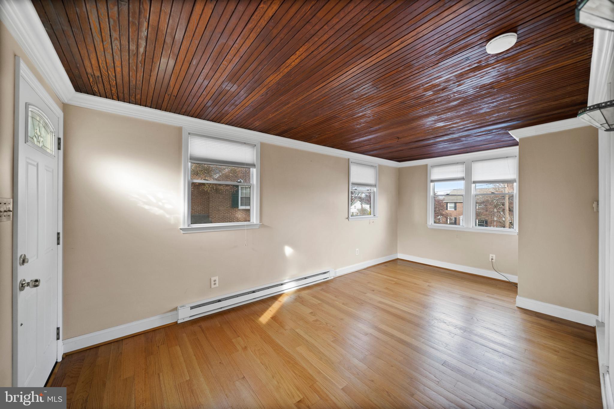 302 Shelbourne Road Havertown, PA 19083 - Photo 33 of 45 an empty room with wooden floor and windows