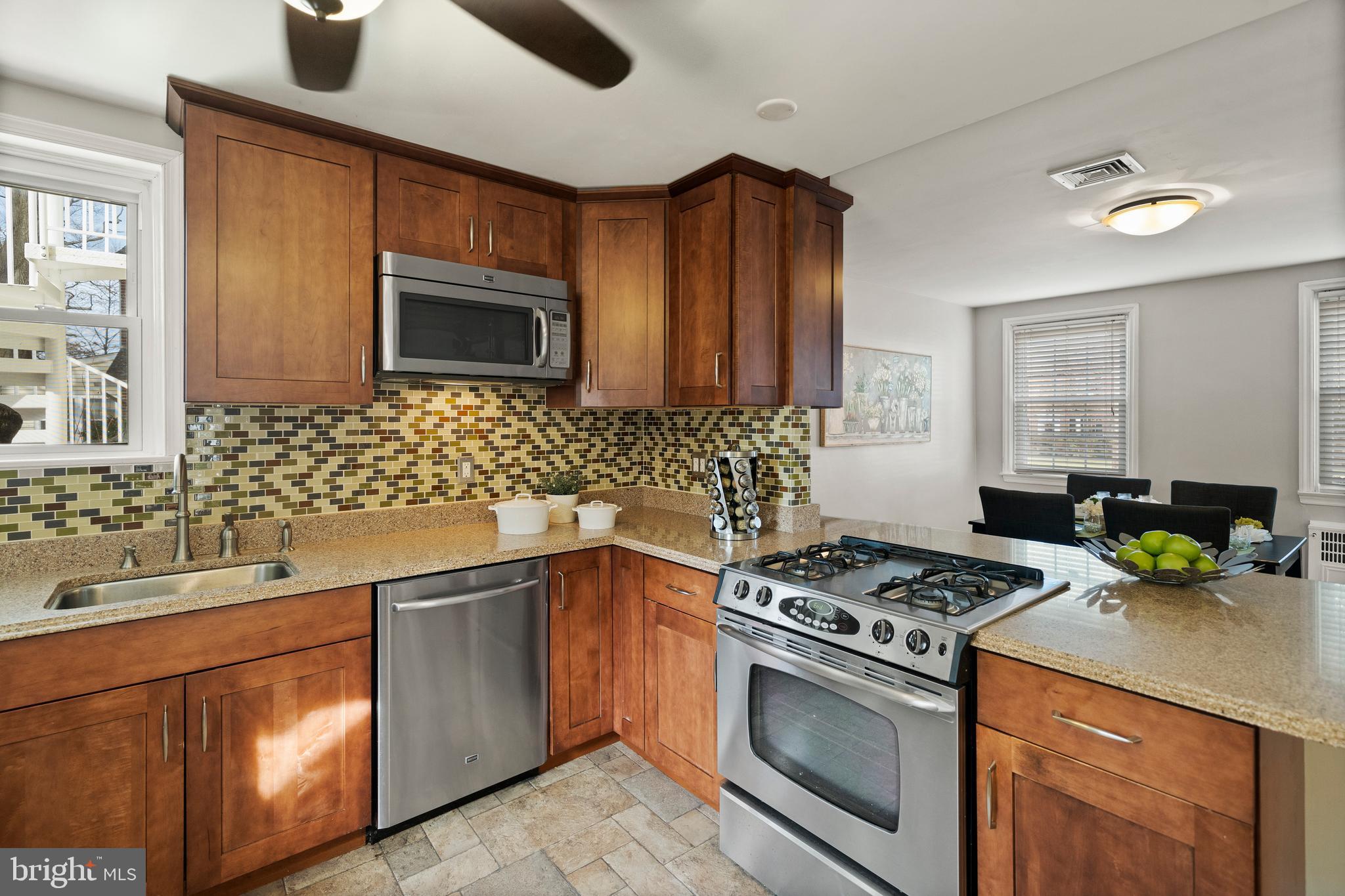 302 Shelbourne Road Havertown, PA 19083 - Photo 10 of 45 a kitchen with stainless steel appliances a stove a sink cabinets and a microwave