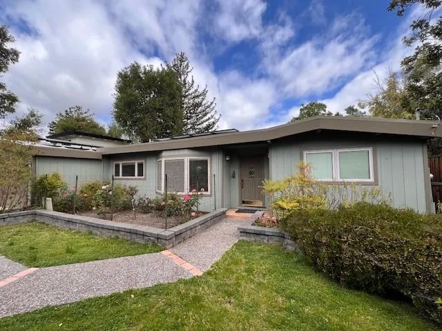 a front view of a house with garden