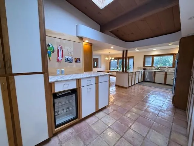 a large kitchen with stainless steel appliances granite countertop a refrigerator and a stove