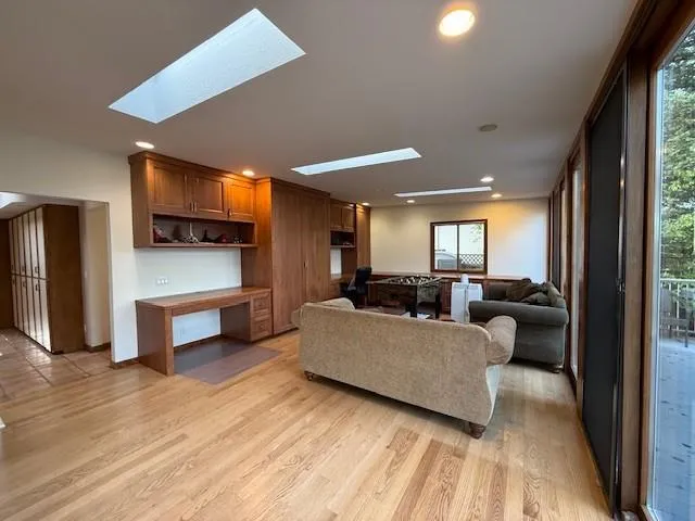 an empty room with windows flat screen tv and windows