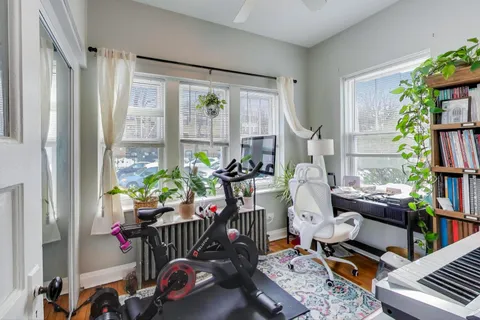 a living room with furniture a rug and a window
