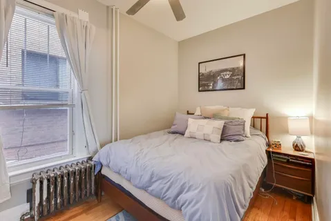 a bedroom with a bed and a window