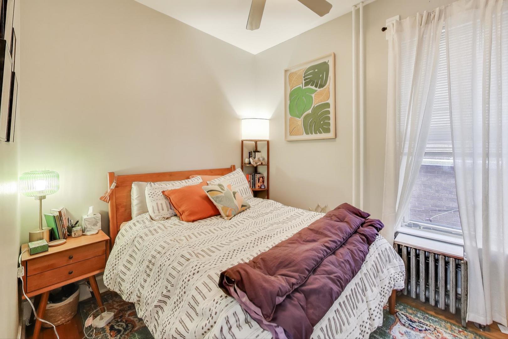 7330 North Honore Street Chicago, IL 60626 - Photo 15 of 43 a bedroom with a bed and wooden floor