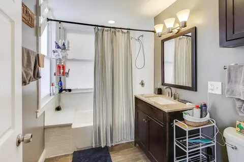 a bathroom with a double vanity sink mirror and shower