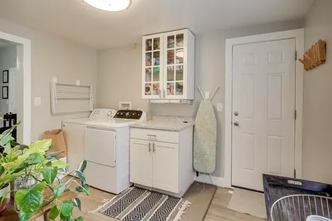 a bathroom with a granite countertop sink a mirror and a shower
