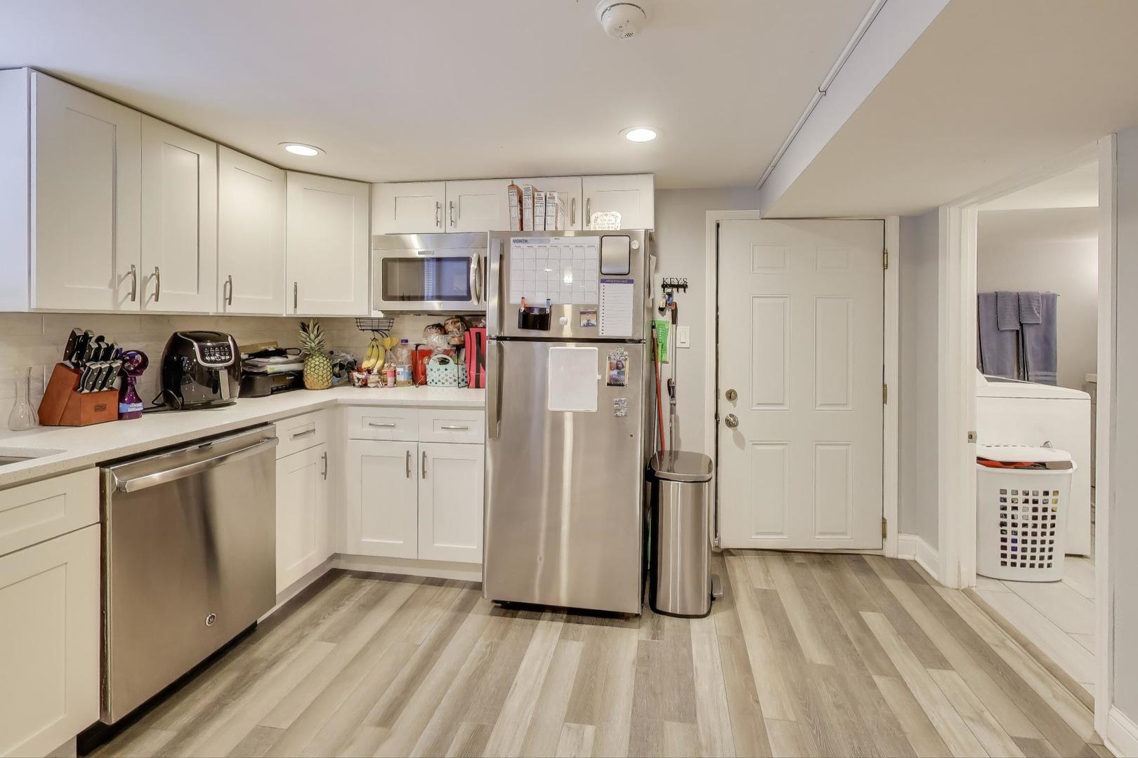 7330 North Honore Street Chicago, IL 60626 - Photo 33 of 43 a kitchen with a refrigerator a sink and cabinets