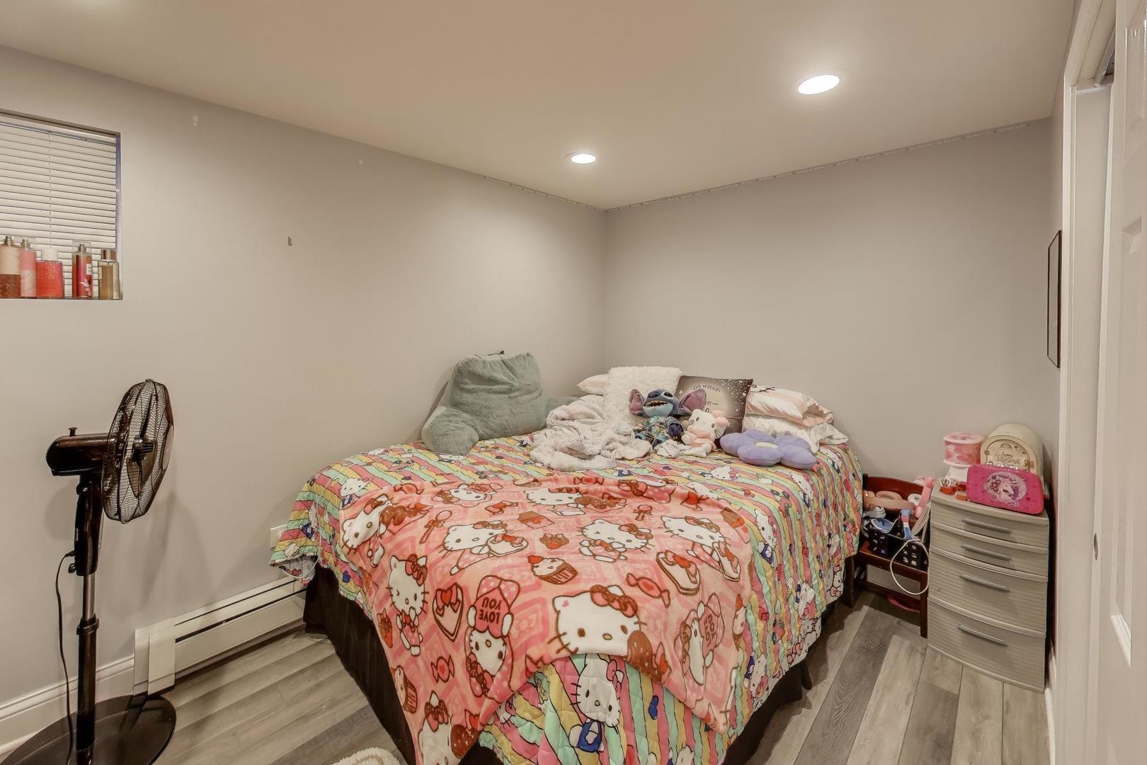 7330 North Honore Street Chicago, IL 60626 - Photo 35 of 43 a bedroom with a bed and a window