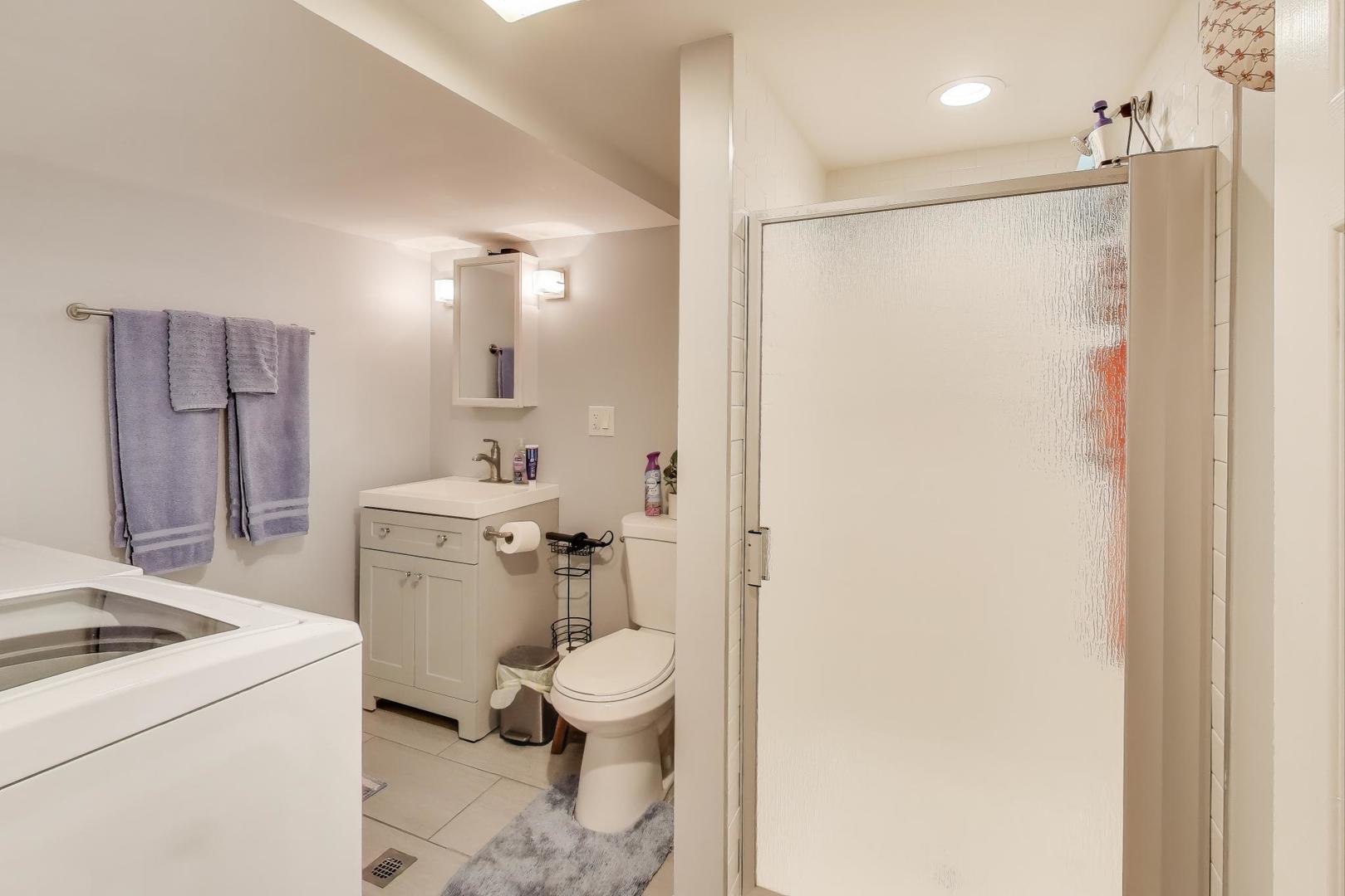 7330 North Honore Street Chicago, IL 60626 - Photo 36 of 43 a bathroom with a granite countertop sink toilet and shower