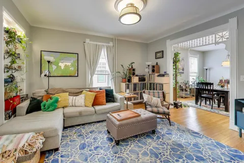 a living room with furniture and wooden floor