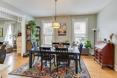a view of a dining room with furniture window and wooden floor