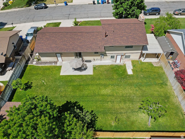865 South 325 West Orem, UT 84058 - Photo 38 of 38 Expansive backyard featuring a large green lawn, concrete patio, and mature trees