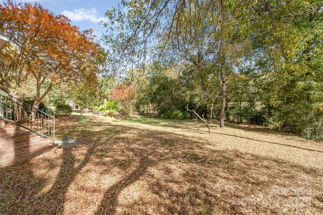 a view of dirt yard with a trees