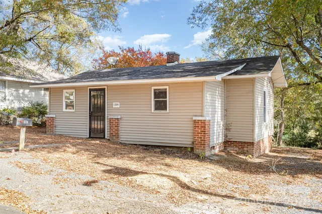 a view of a house with a yard and garage