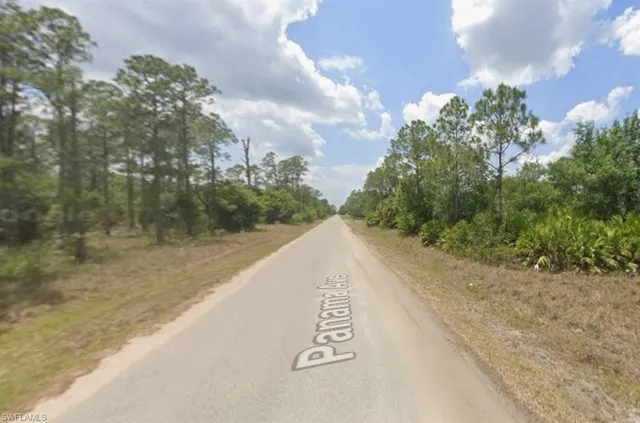 a view of a street with a trees in the background