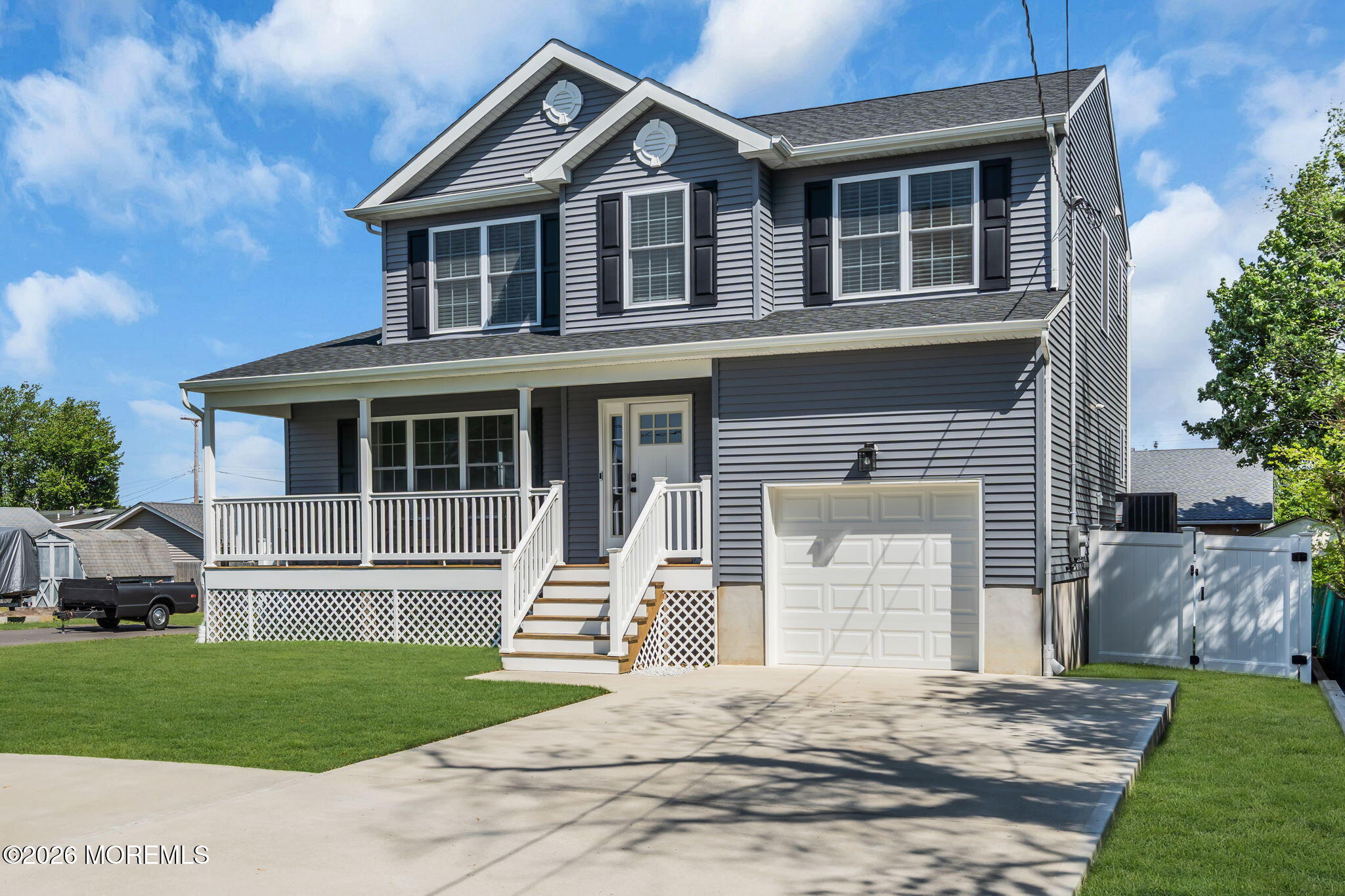 312 Beach Boulevard Forked River, NJ 08731 - Photo 1 of 40 a front view of a house with a yard and garage