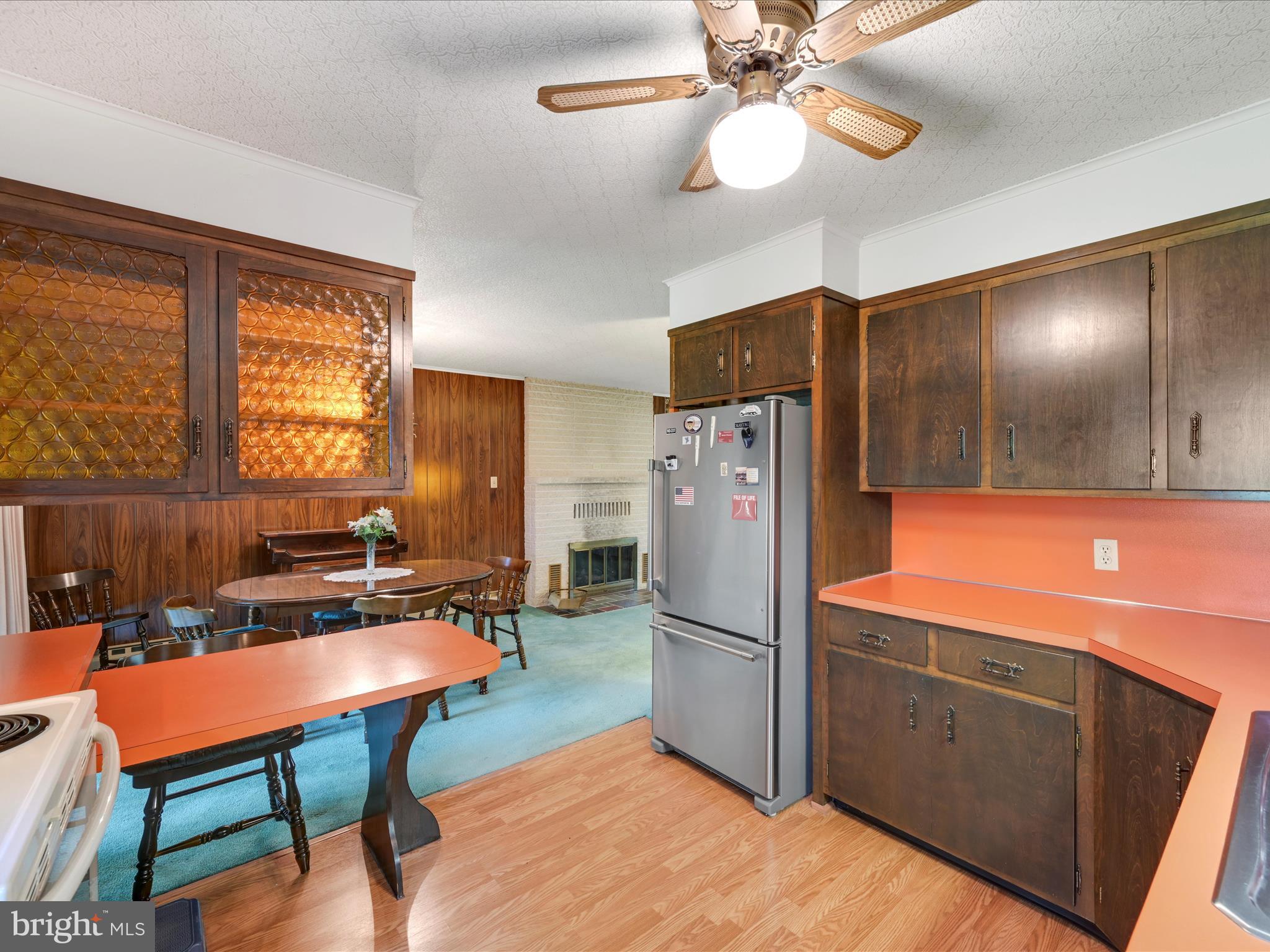 858 Hill Road Ashland, PA 17921 - Photo 11 of 41 a kitchen with stainless steel appliances granite countertop a refrigerator a sink dishwasher a dining table and chairs with wooden floor