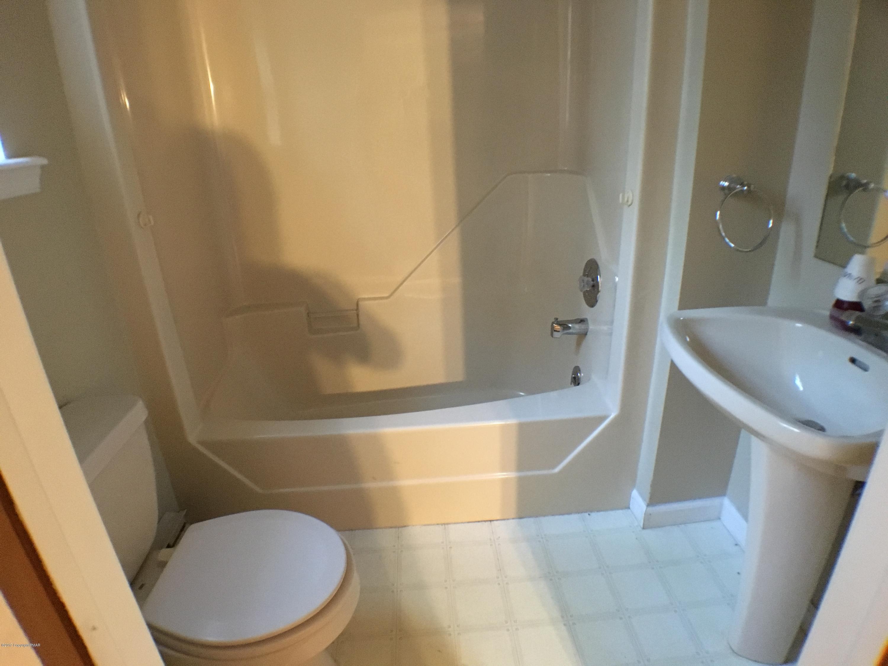 2185 Hill Road Effort, PA 18330 - Photo 12 of 17 a white toilet sitting next to a bath tub
