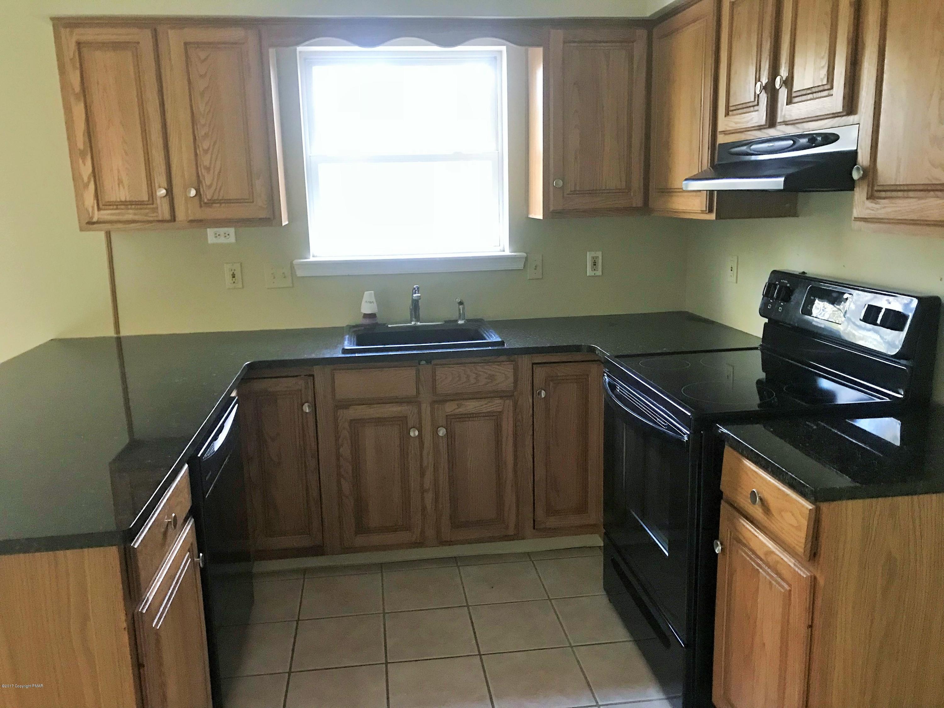 2185 Hill Road Effort, PA 18330 - Photo 17 of 17 a kitchen with granite countertop a sink stove and cabinets