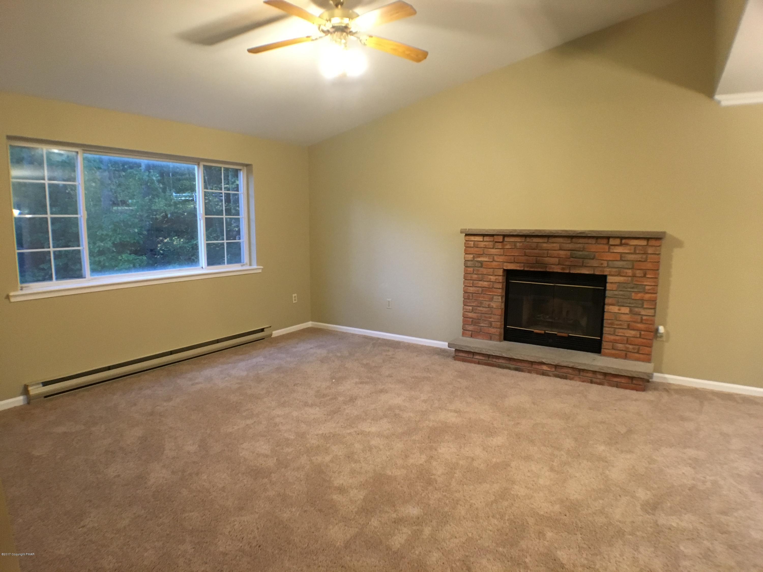 2185 Hill Road Effort, PA 18330 - Photo 2 of 17 an empty room with windows and fireplace