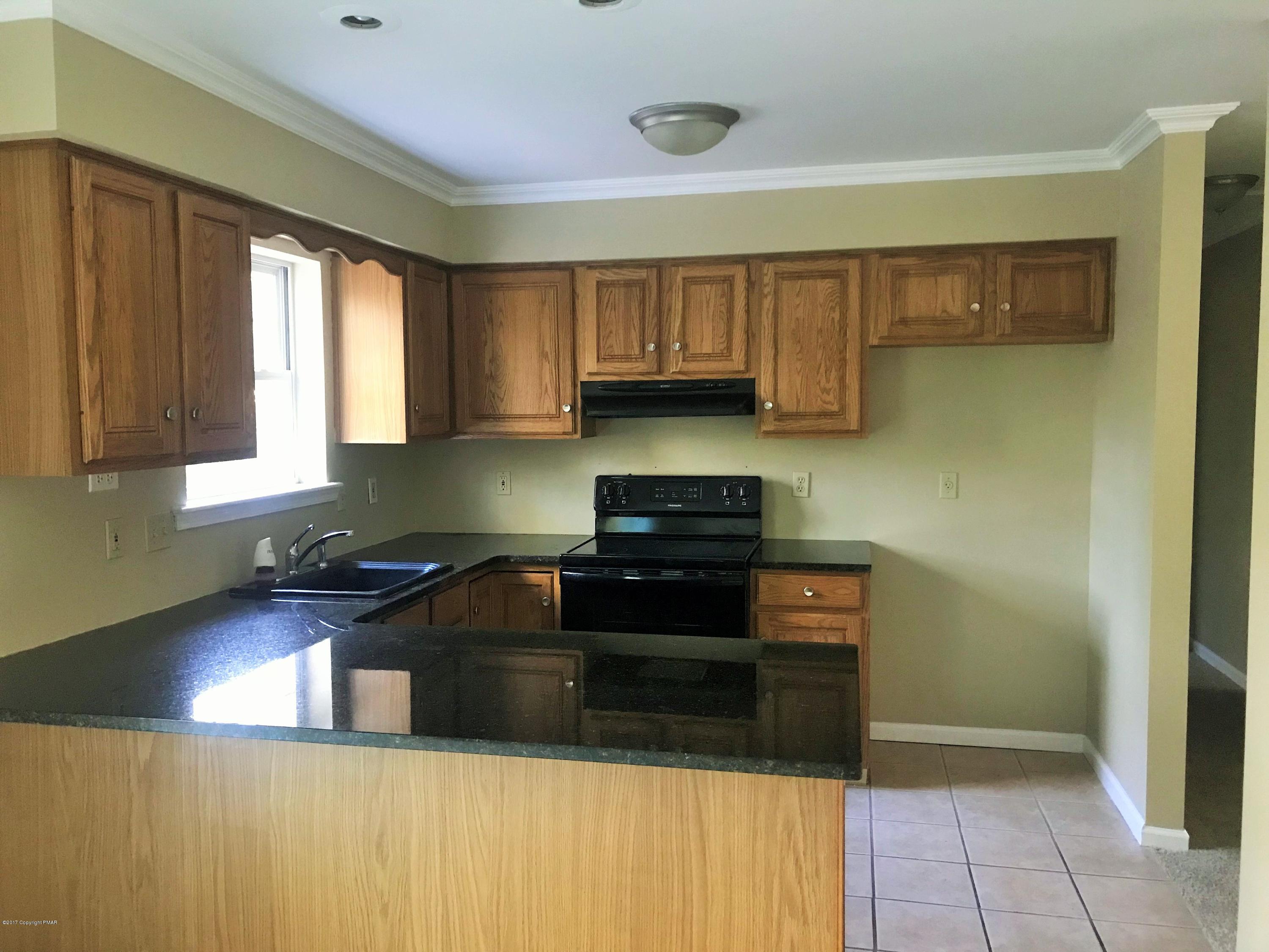 2185 Hill Road Effort, PA 18330 - Photo 5 of 17 a kitchen with stainless steel appliances granite countertop a stove a sink and a microwave