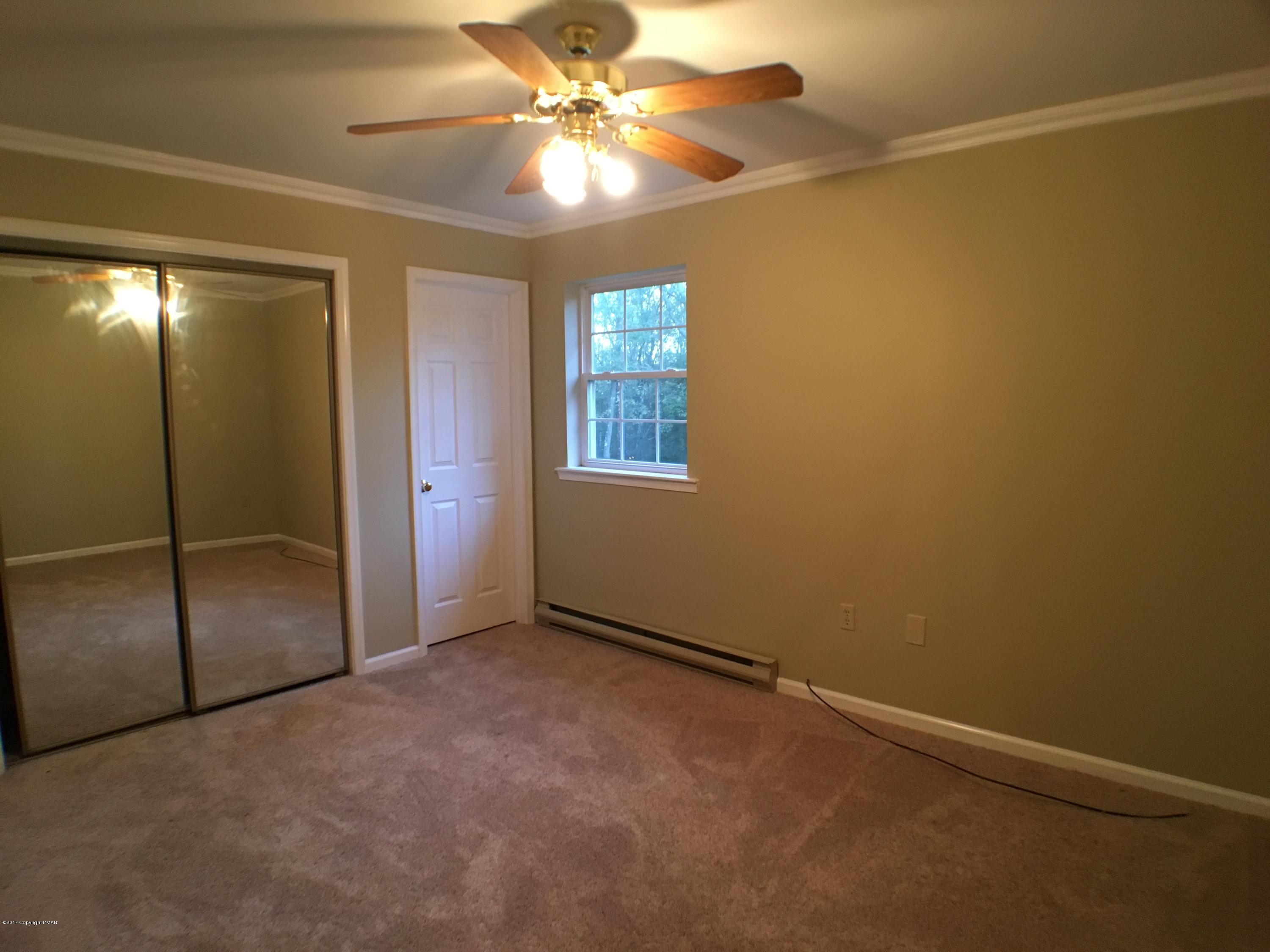 2185 Hill Road Effort, PA 18330 - Photo 9 of 17 an empty room with windows and fan