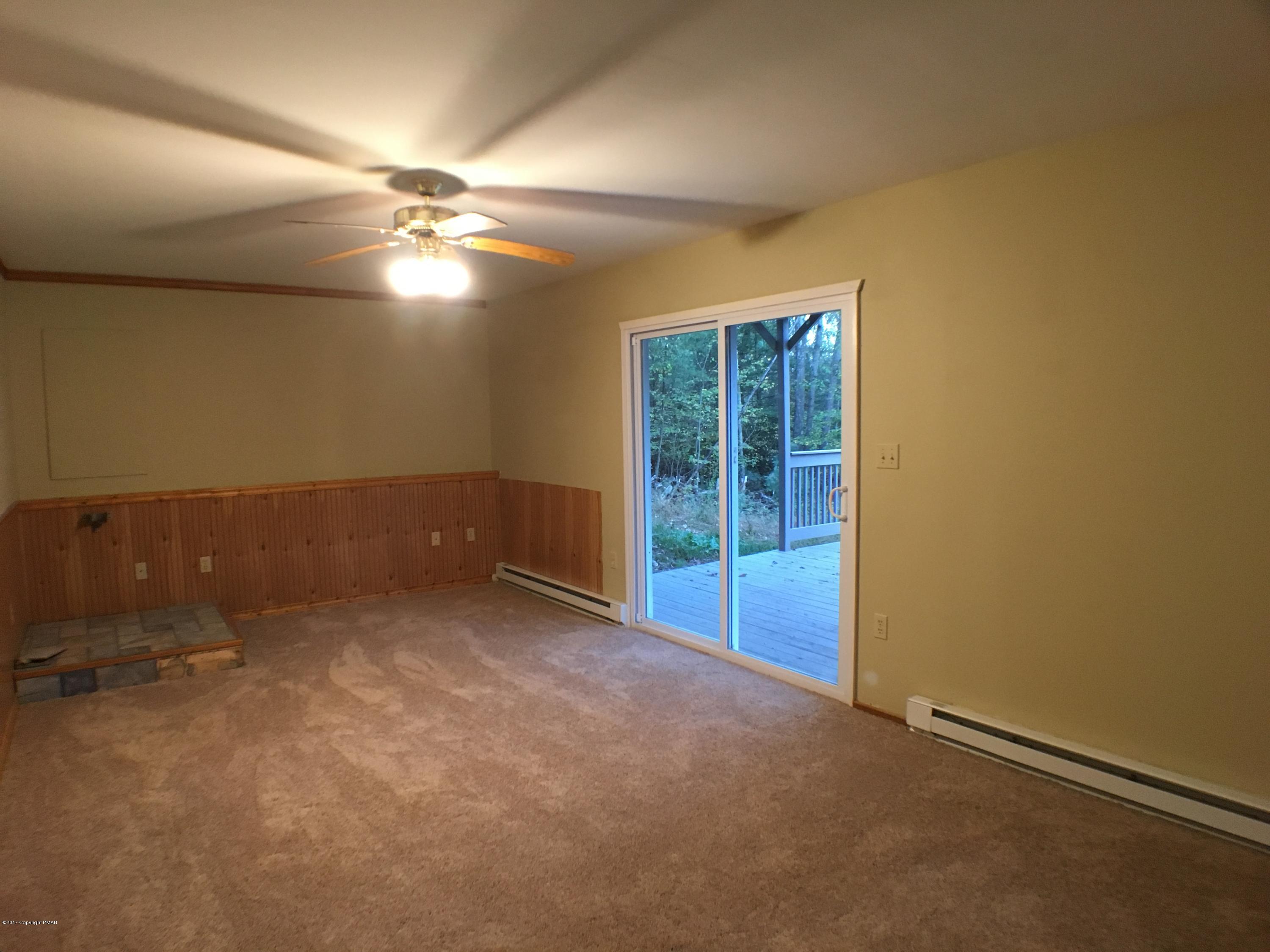 2185 Hill Road Effort, PA 18330 - Photo 10 of 17 an empty room with chandelier fan and windows