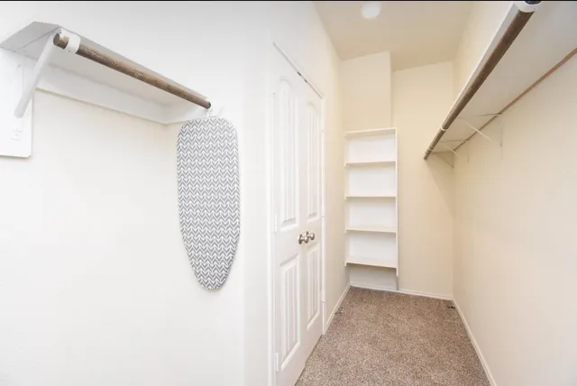 a spacious bathroom with a shower sink and a mirror