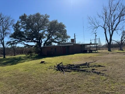 a view of a backyard with wooden fence