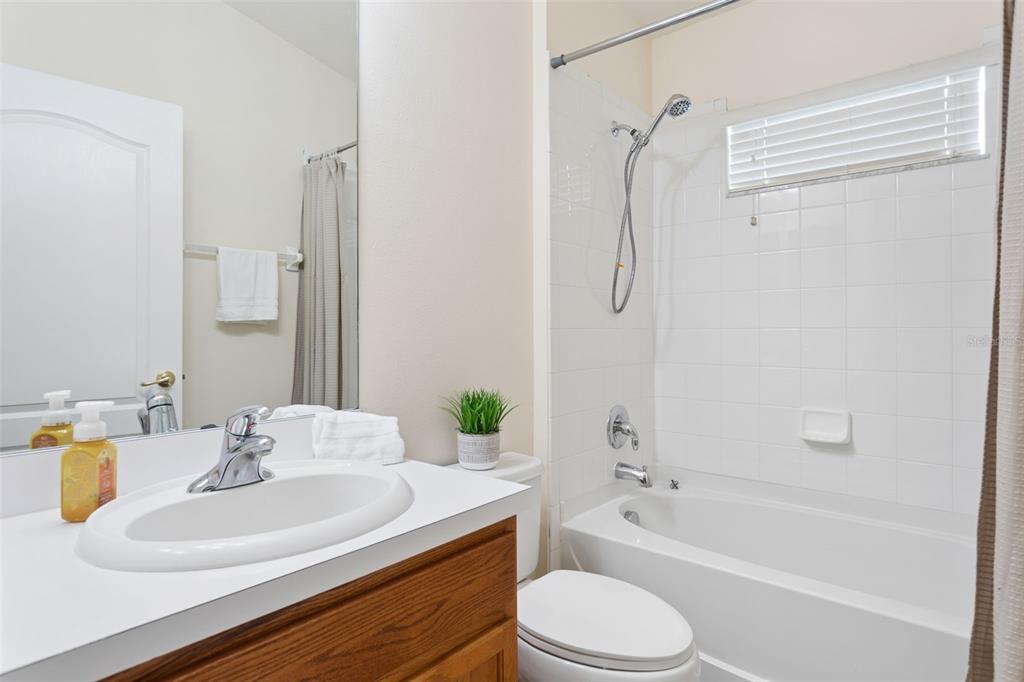 25932 Terrawood Loop Land O Lakes, FL 34639 - Photo 15 of 28 a bathroom with a granite countertop sink toilet and shower