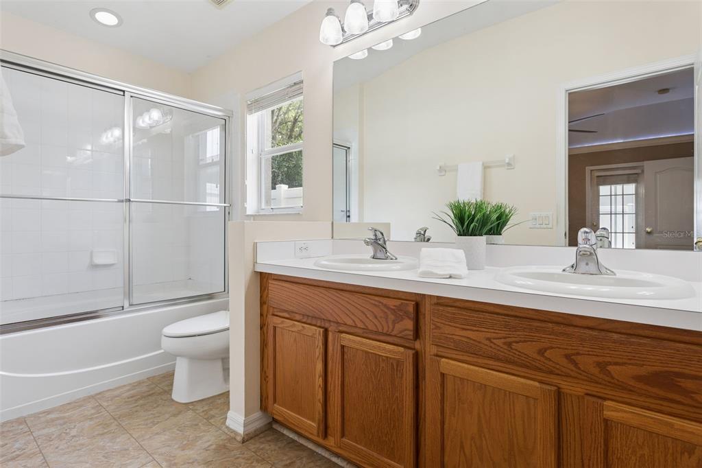 25932 Terrawood Loop Land O Lakes, FL 34639 - Photo 20 of 28 a bathroom with a double vanity sink toilet and shower