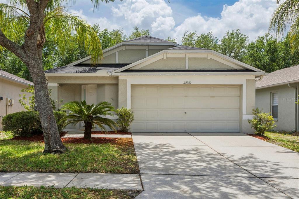 25932 Terrawood Loop Land O Lakes, FL 34639 - Photo 2 of 28 a front view of a house with garden
