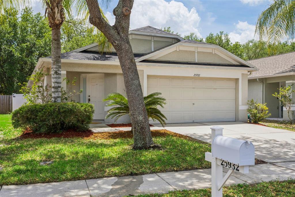 25932 Terrawood Loop Land O Lakes, FL 34639 - Photo 3 of 28 a front view of a house with garden