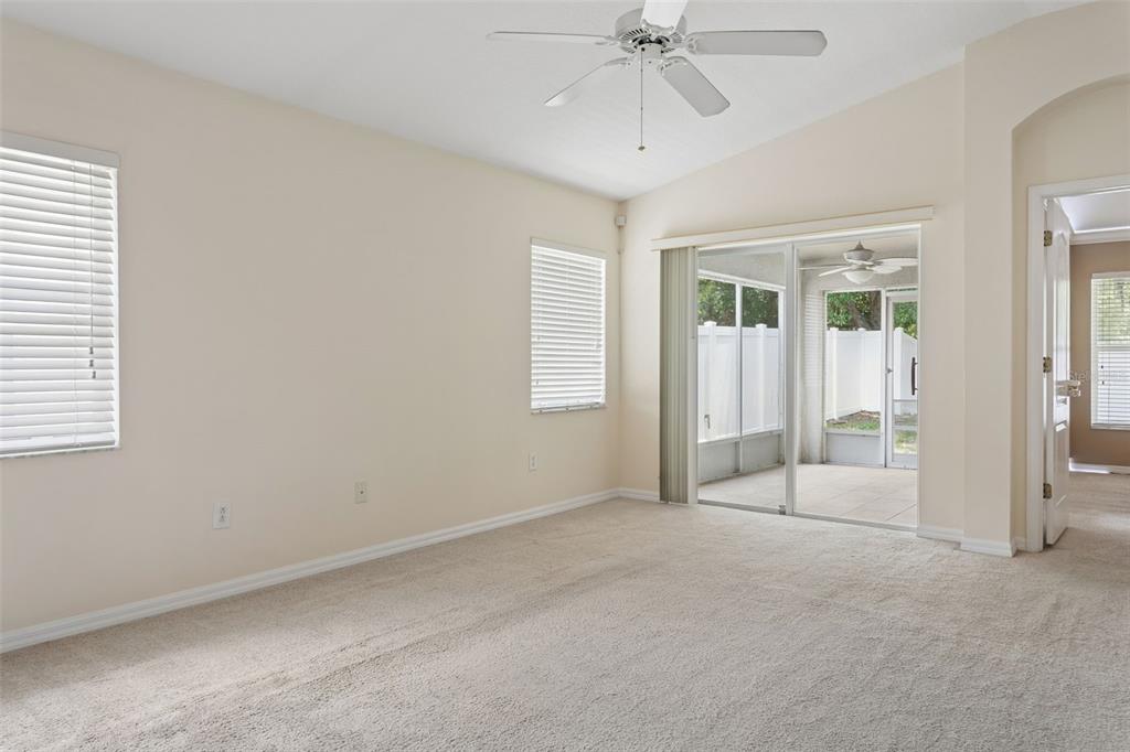 25932 Terrawood Loop Land O Lakes, FL 34639 - Photo 8 of 28 an empty room with chandelier fan and windows