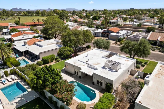 an aerial view of a house with a yard garage and lake view