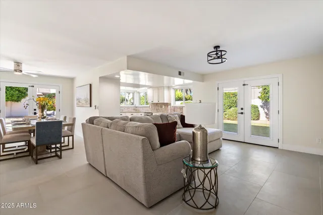 a living room with furniture and a table with wooden floor